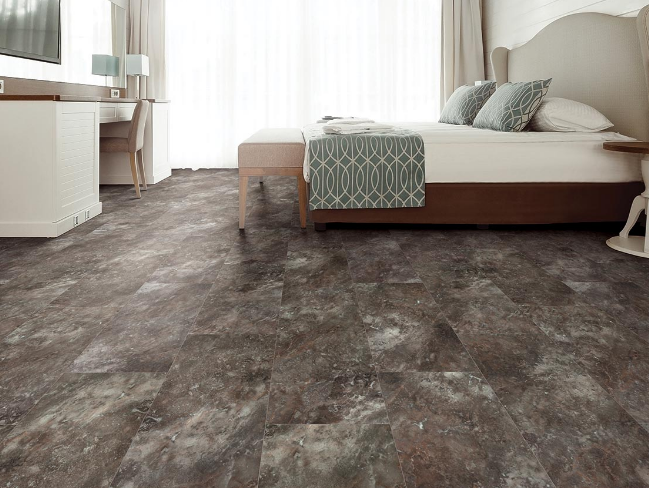 Warm slate grey patterned stone look lvt floors create a clean, earthy aesthetic that brings tranquility to a modern white bedroom.