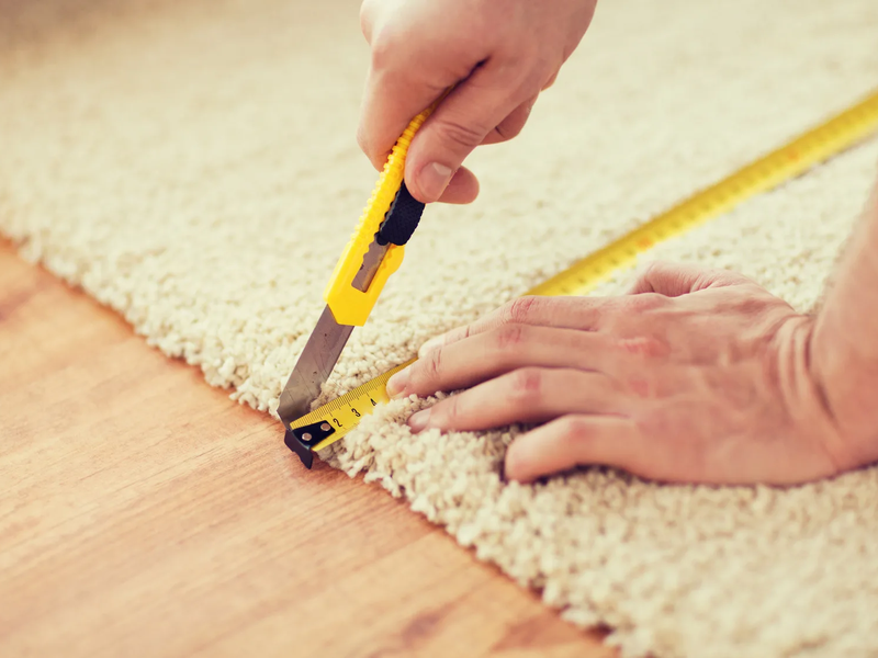 Contractor cutting a carpet in Indianapolis, IN