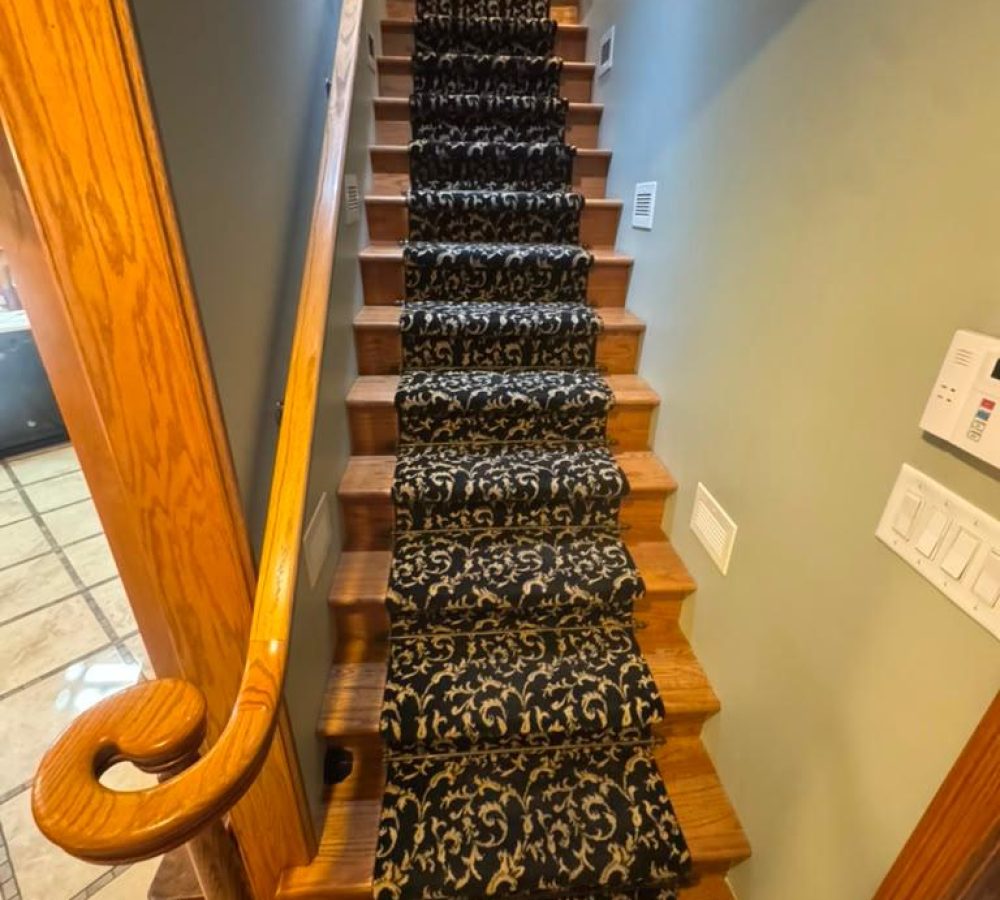 black-gold-patterned-stair-runner-installation